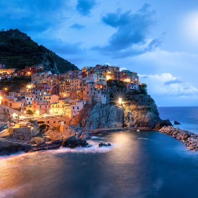 blue-moon-and-manarola-village-at-night-cinque-te-2023-11-27-05-29-06-utc