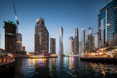 Panoramic view with modern skyscrapers and water channel of Dubai Marina in evening, United Arab Emirates